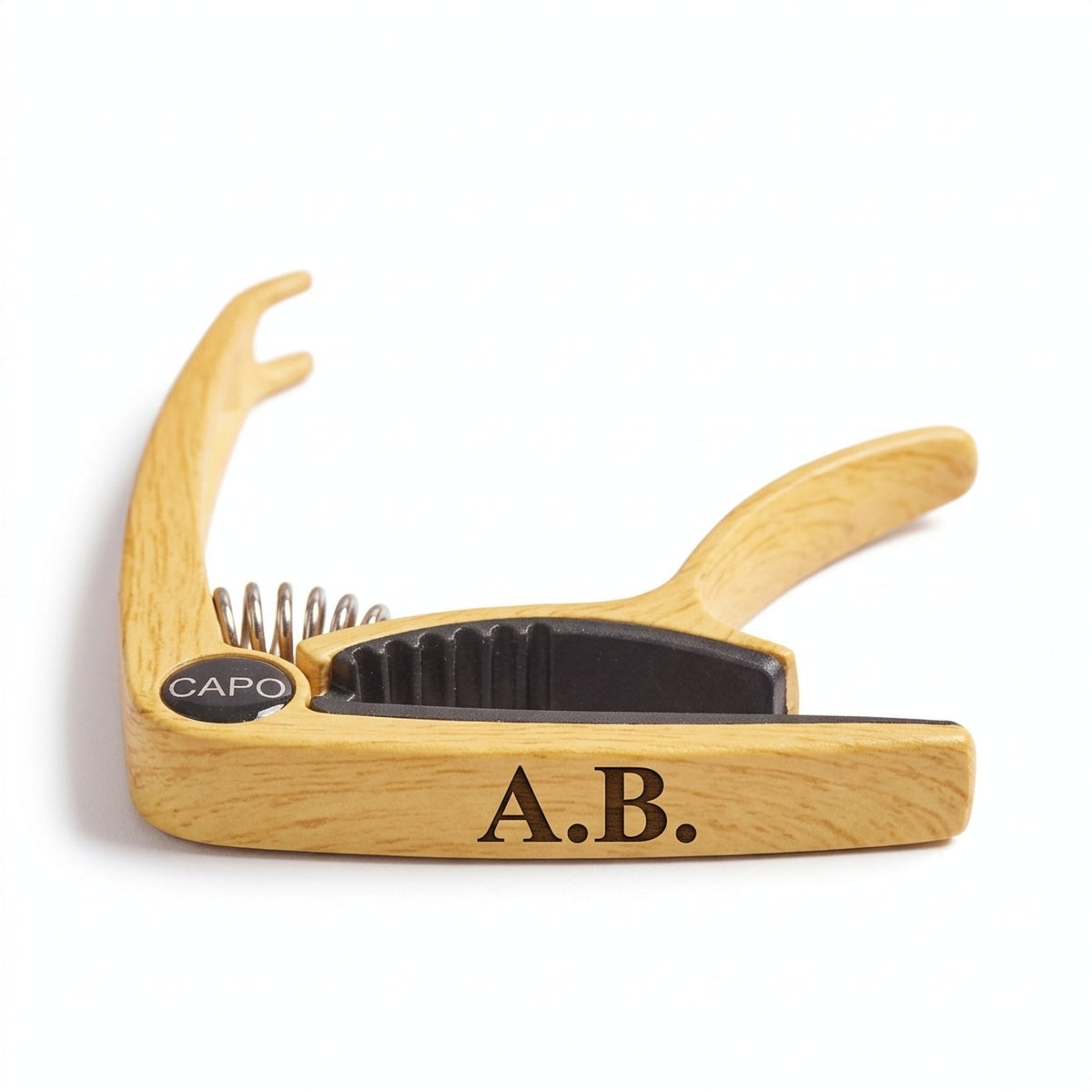 Personalised light wood finish guitar capo engraved with initials A.B.