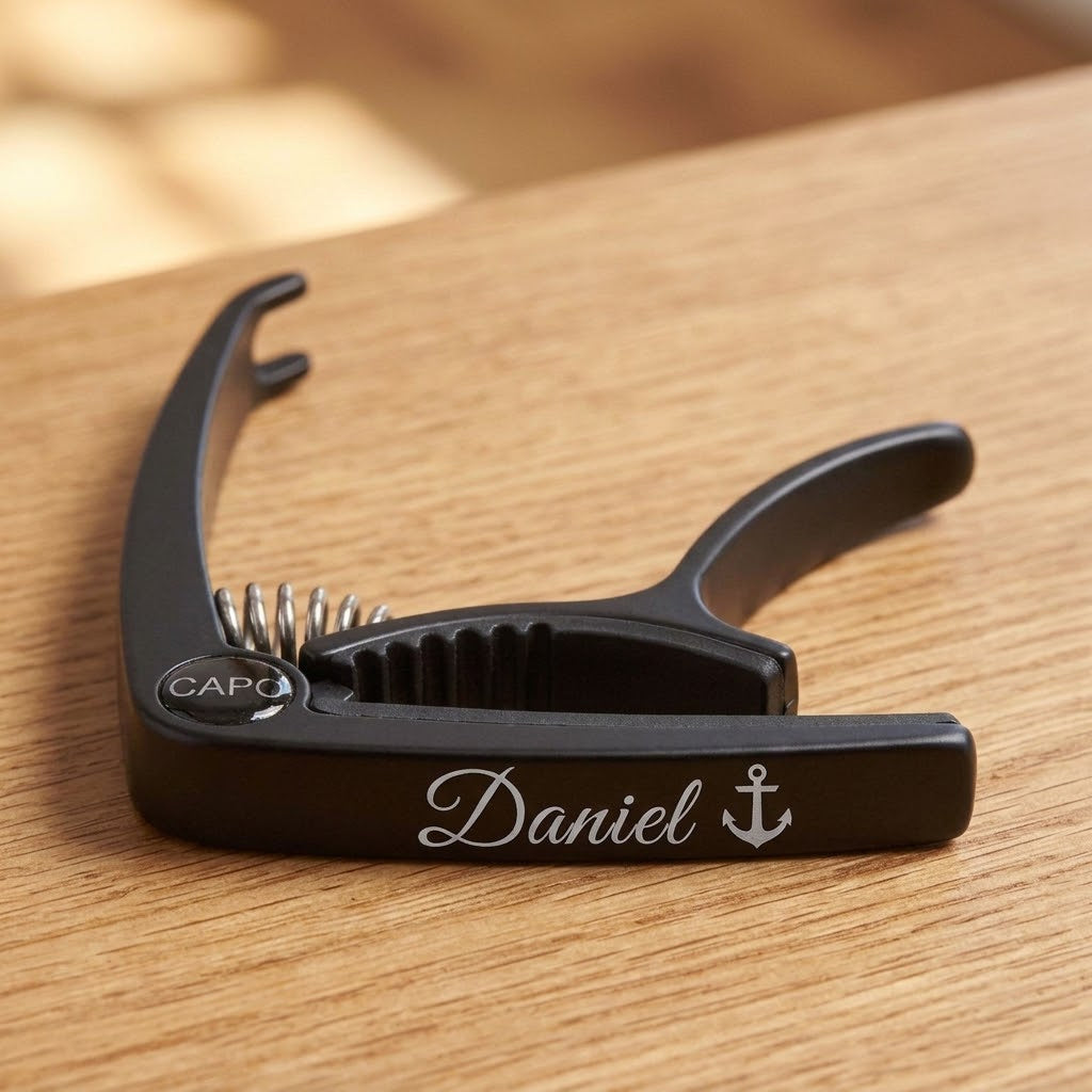 Personalised black metal guitar capo engraved with Daniel and an anchor