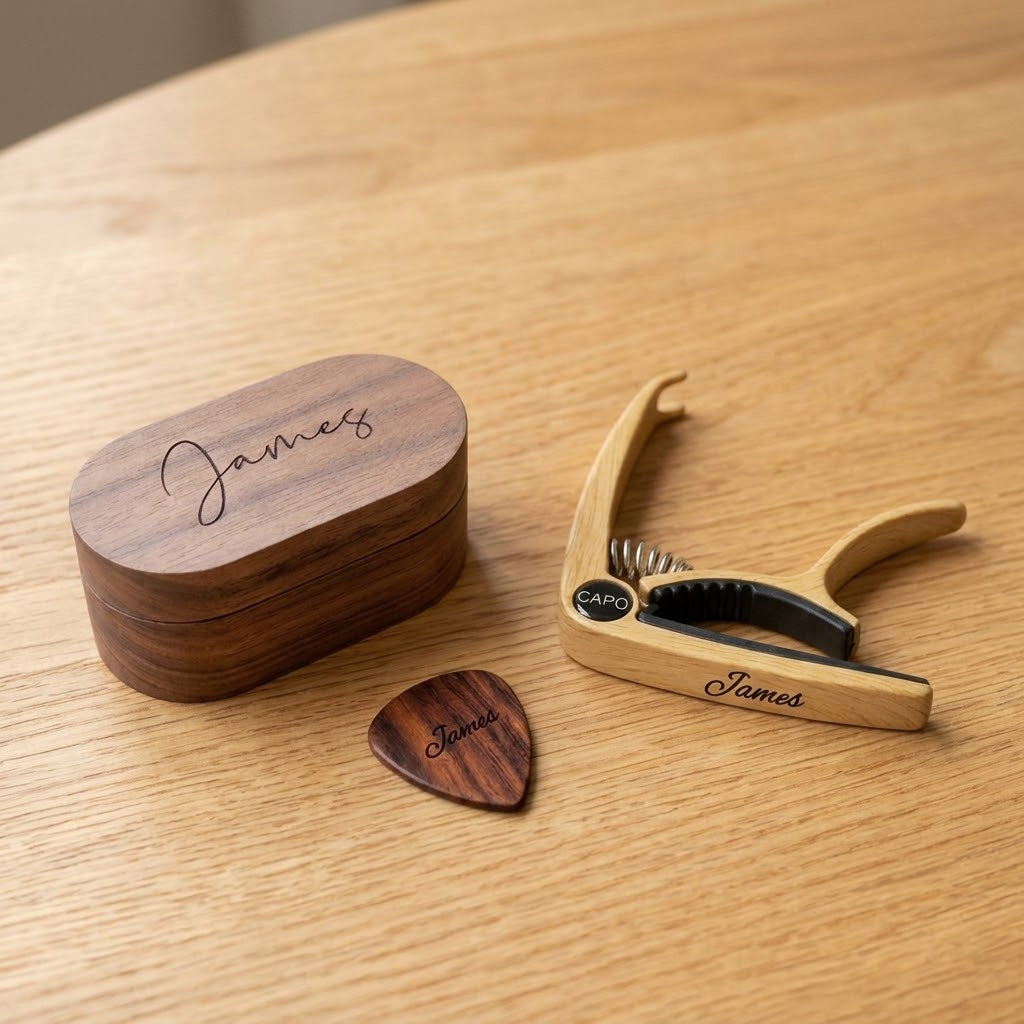 Personalised guitar gift set: engraved oval pick box, wooden pick and capo, all engraved James
