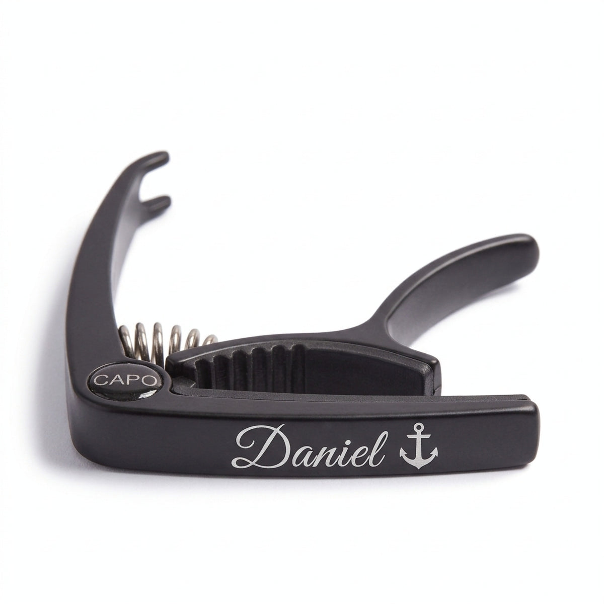 Personalised black metal guitar capo engraved with Daniel and an anchor